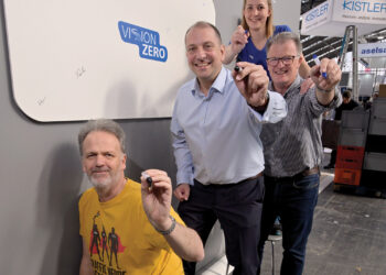 Sign your name: Tobias Deubel (centre) and Anika Häger of Jenoptik with members of the ITS International team