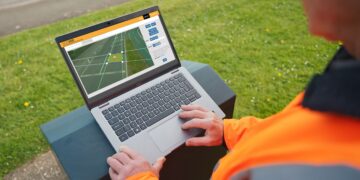 Traffic engineer at roadside looks at laptop screen (image: AGD Systems)