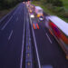 Trucks and cars blur at twilight on right side of highway (image: Iñaki Polo | Dreamstime.com)