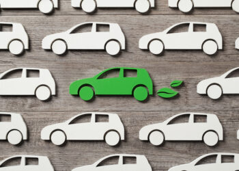 Illustration of identical white cars with one green car in the middle, green leaves coming out of its exhaust(image: Rido/Dreamstime.com)