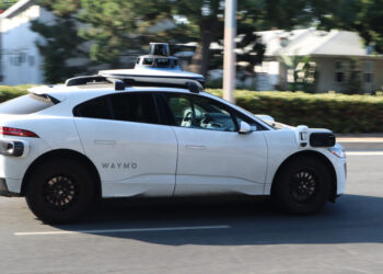White Waymo AV driving on city street (image: Delgado63/Dreamstime.com)