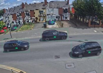 Three cars on a road with pixelated houses behind (image: Yunex Traffic)