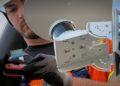 Engineer installing Ouster BlueCity Lidar on existing traffic pole (image: Ouster/Econolite)